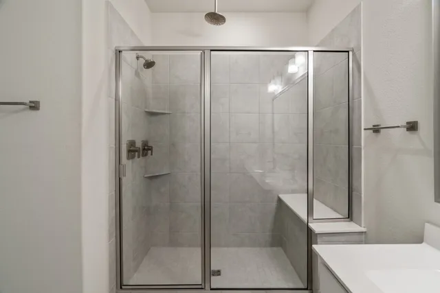 a bathroom with a shower and a sink