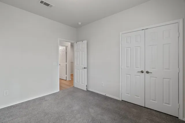 a view of an empty room and closet area