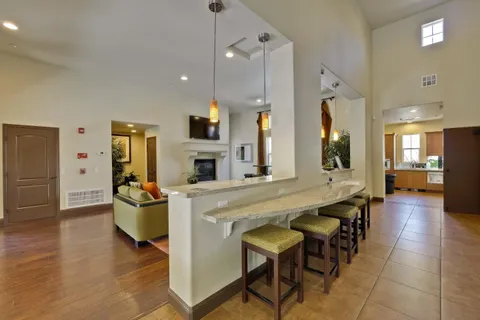 a large kitchen with a table and chairs