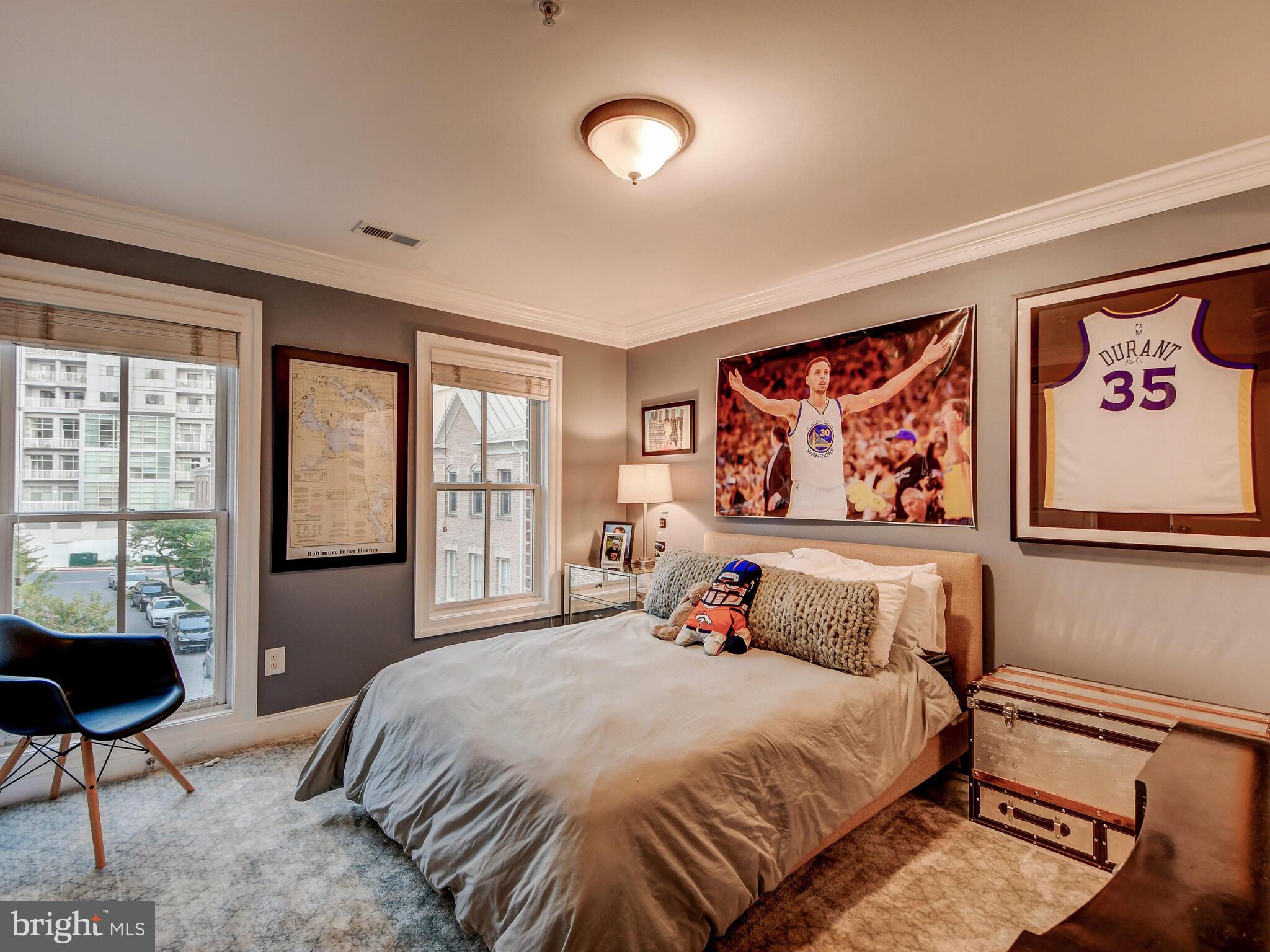 1230 Dockside Circle Baltimore, MD 21224 - Photo 28 of 70 a bedroom with a bed and a painting on the wall