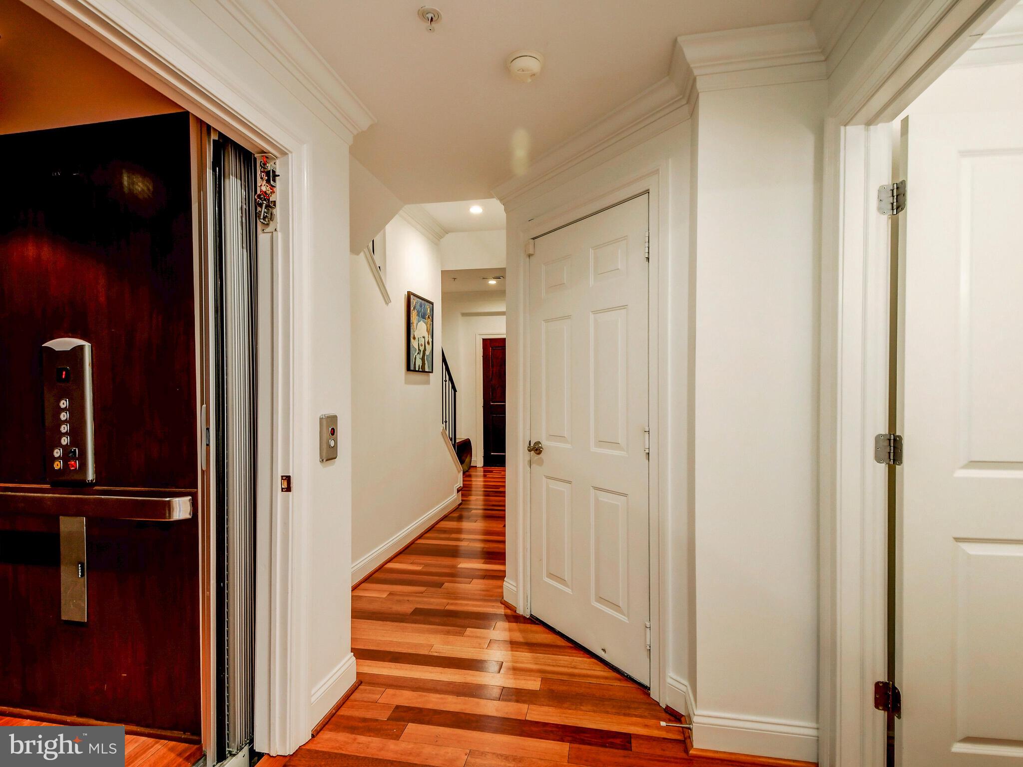 1230 Dockside Circle Baltimore, MD 21224 - Photo 39 of 70 a view of a hallway with wooden floor and staircase