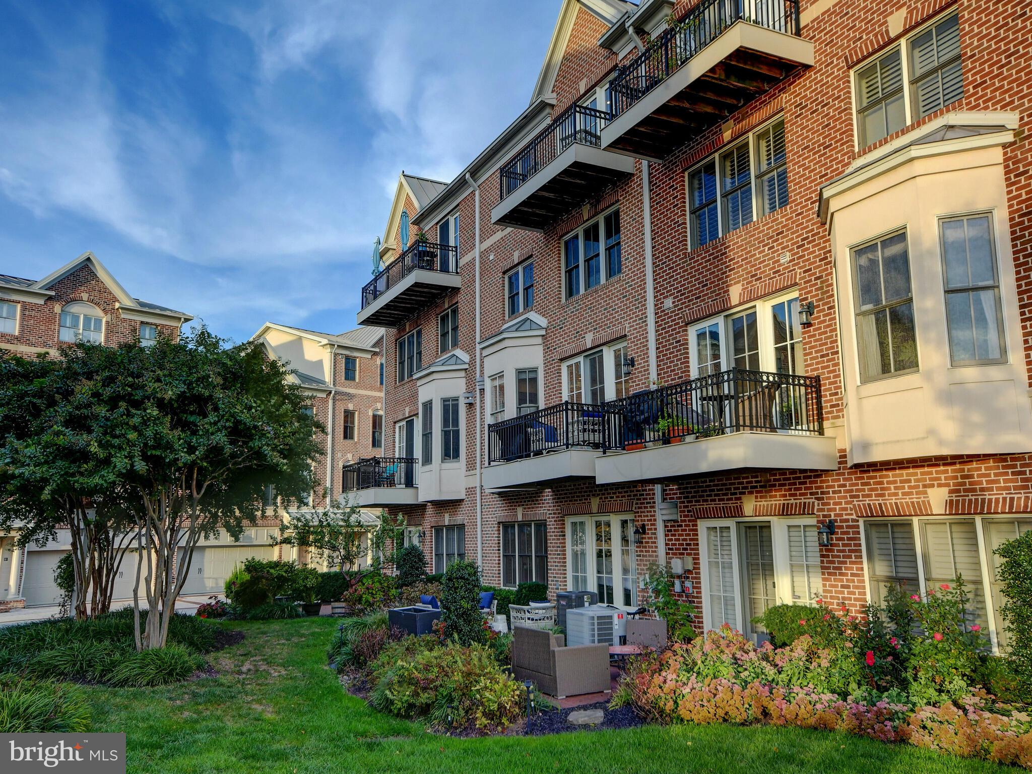 1230 Dockside Circle Baltimore, MD 21224 - Photo 49 of 70 a front view of a residential apartment building with a yard and plants