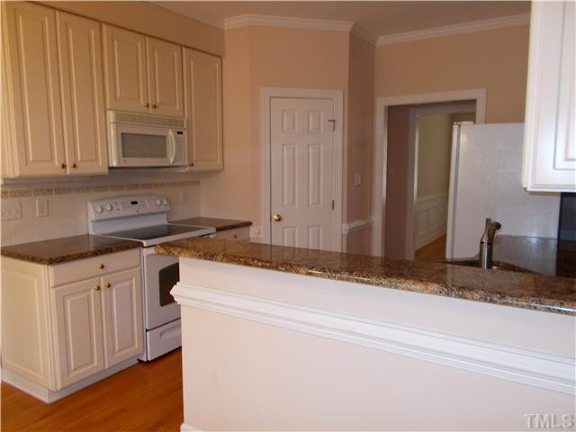 8417 Wycombe Ridge Way Wake Forest, NC 27587 - Photo 6 of 25 Kitchen with corner pantry, hardwoods, tile backsplash, and granite countertops Kitchen