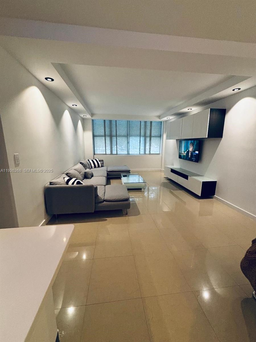 7441 Wayne Avenue, Unit 1R Miami Beach, FL 33141 - Photo 12 of 25 a living room with furniture and kitchen view