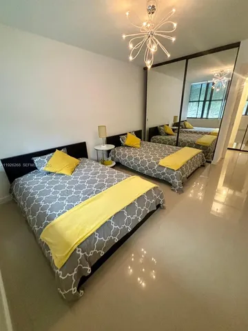 a living room with furniture gym equipment and a flat screen tv