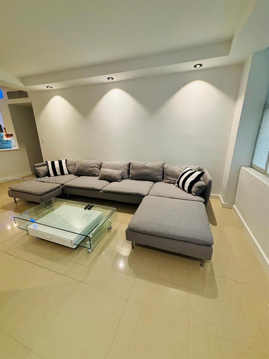 7441 Wayne Avenue, Unit 1R Miami Beach, FL 33141 - Photo 17 of 25 a living room with furniture and a flat screen tv