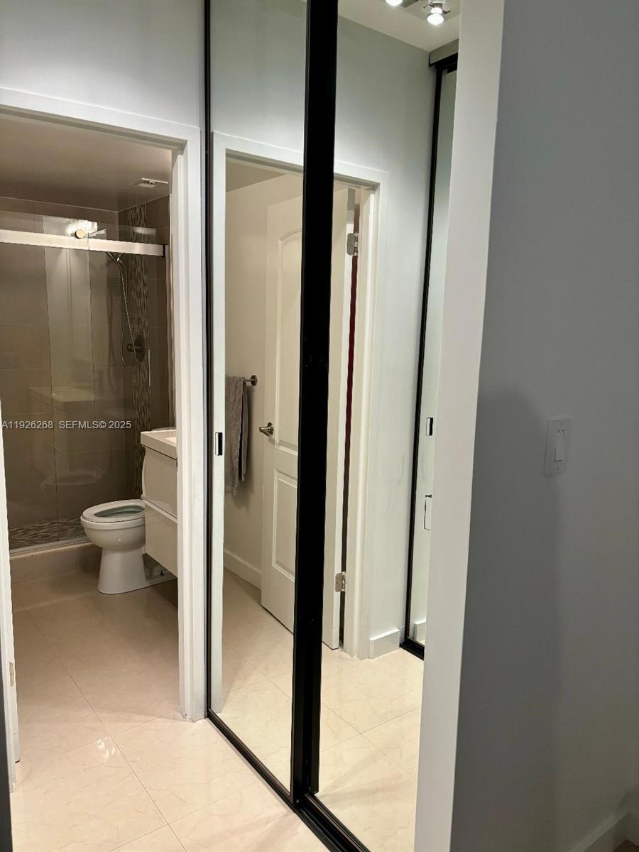 7441 Wayne Avenue, Unit 1R Miami Beach, FL 33141 - Photo 21 of 25 a bathroom with a glass door shower