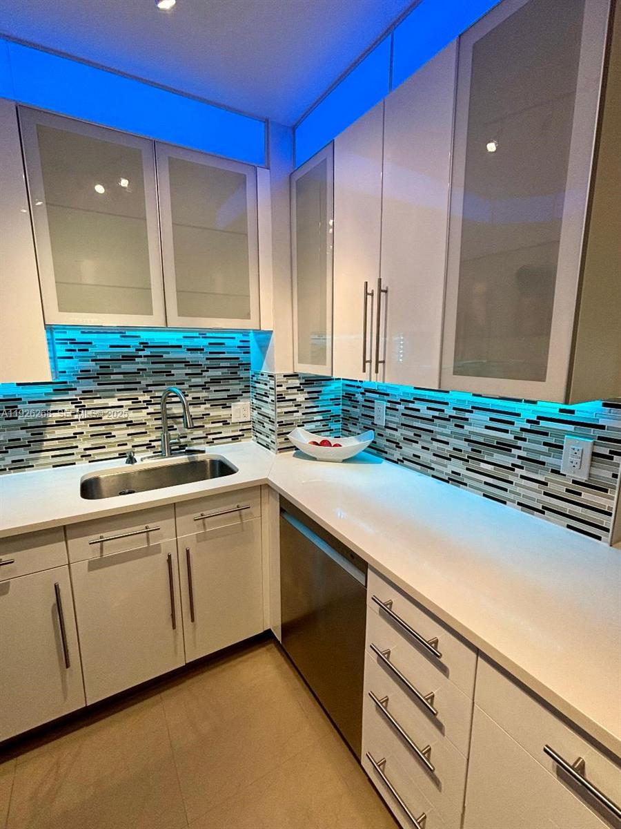 7441 Wayne Avenue, Unit 1R Miami Beach, FL 33141 - Photo 3 of 25 a kitchen with sink cabinets and a counter top space