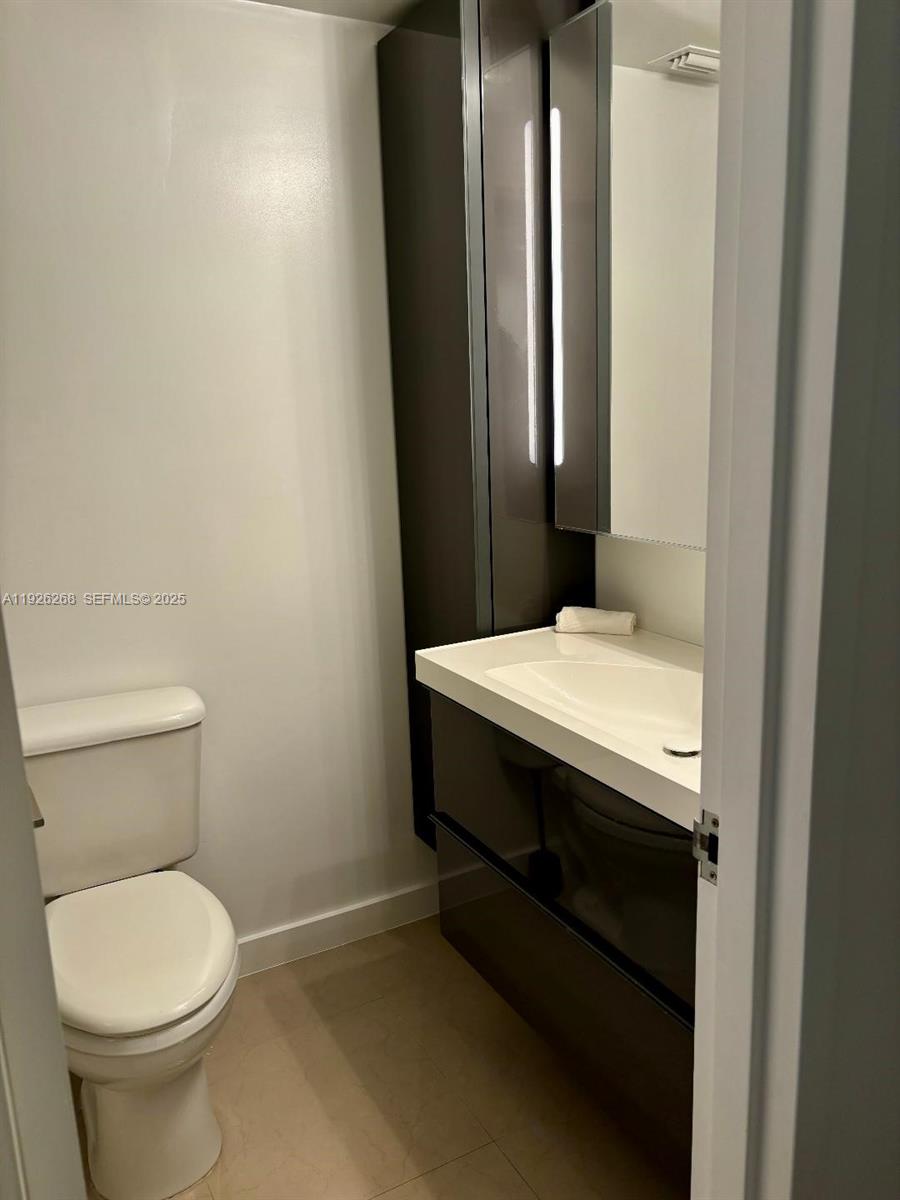 7441 Wayne Avenue, Unit 1R Miami Beach, FL 33141 - Photo 6 of 25 a bathroom with a sink and a toilet