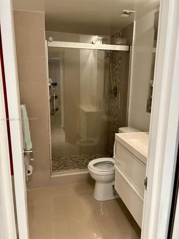 a bathroom with a shower and a toilet