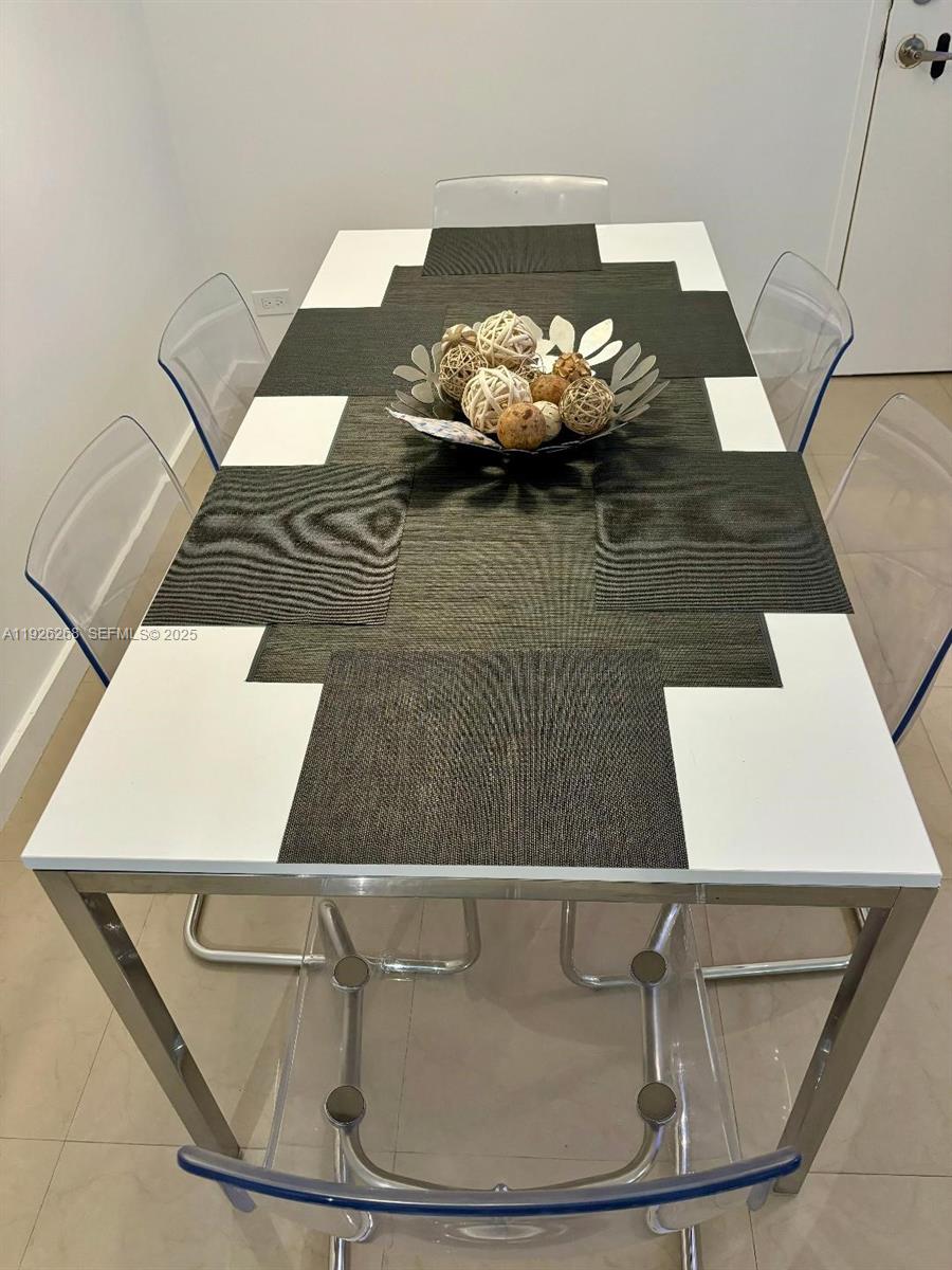 7441 Wayne Avenue, Unit 1R Miami Beach, FL 33141 - Photo 10 of 25 a view of a dining room with wooden floor