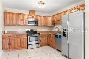 a kitchen with stainless steel appliances granite countertop a refrigerator stove and sink