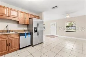 a kitchen with granite countertop a refrigerator and a sink