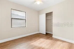an empty room with windows and closet