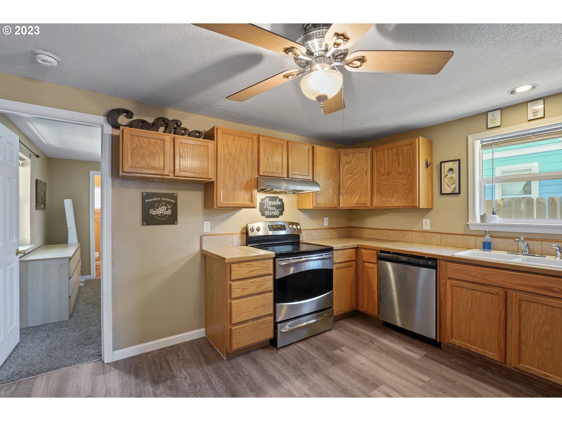 760 28th Street Springfield, OR 97477 - Photo 12 of 30 a kitchen with stainless steel appliances granite countertop a sink and cabinets