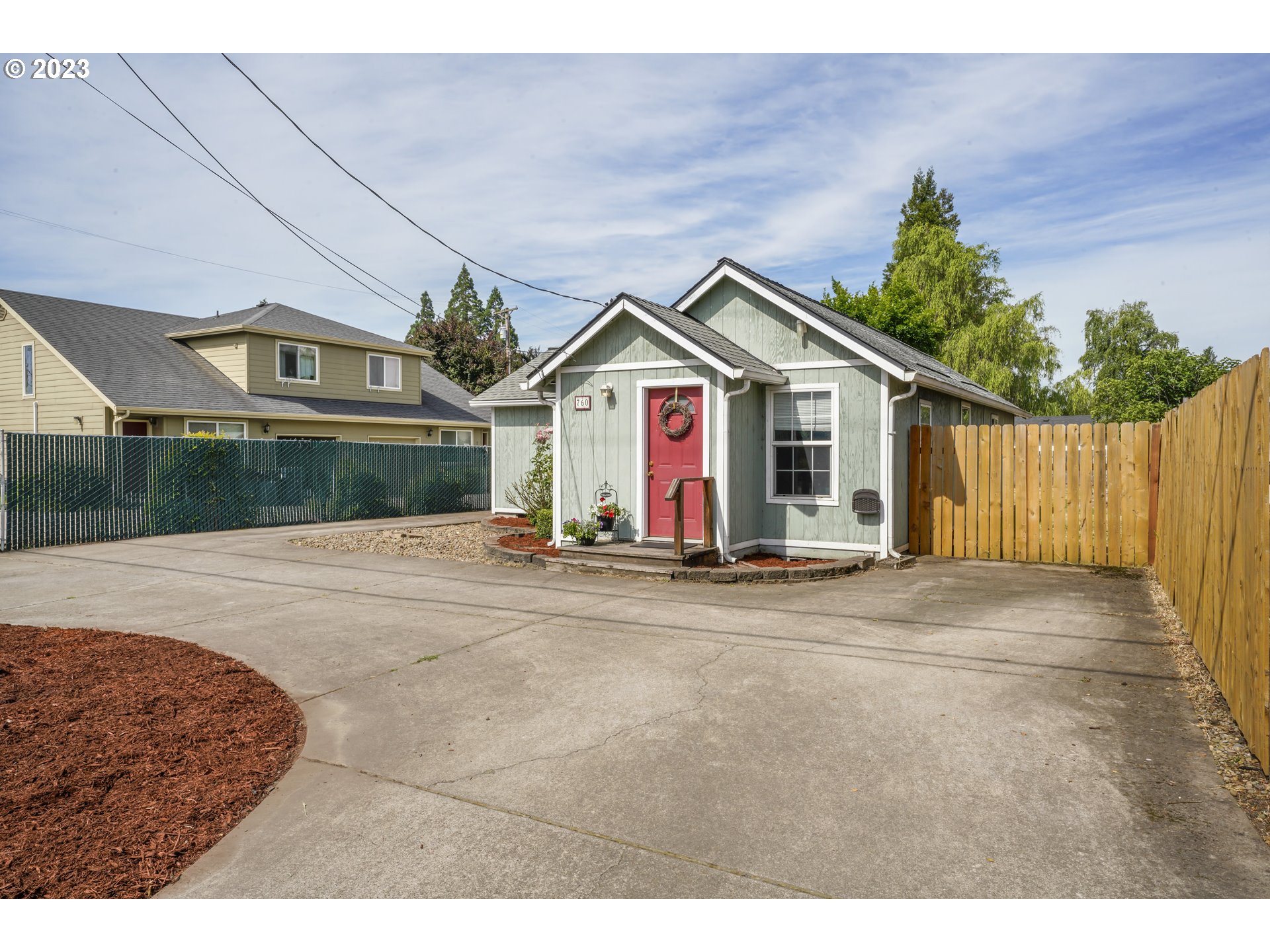 760 28th Street Springfield, OR 97477 - Photo 3 of 30 a view of a white house with a small yard and a large parking space