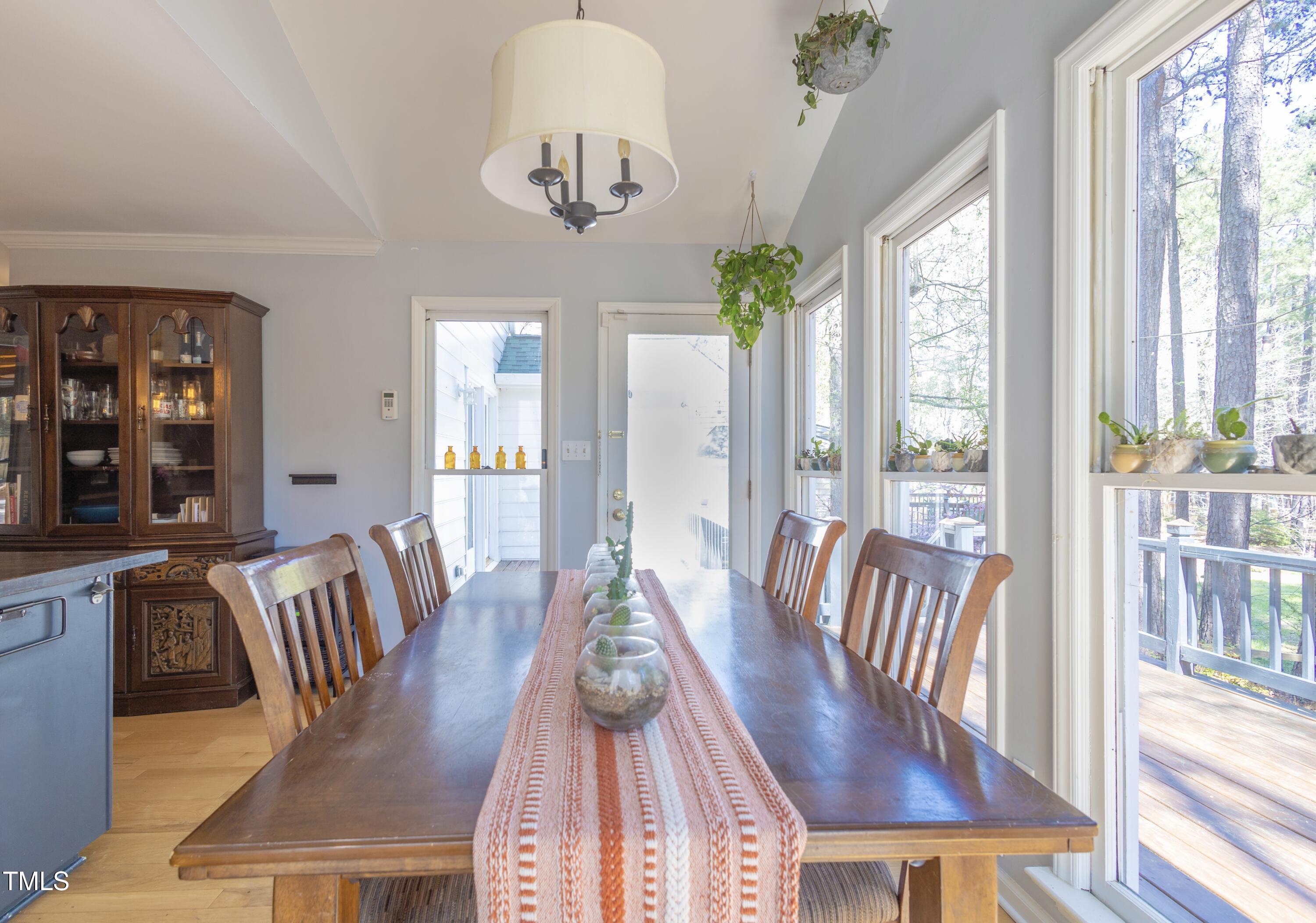 116 Lakeshore Drive Durham, NC 27713 - Photo 12 of 36 a view of a dining room with furniture a chandelier and wooden floor