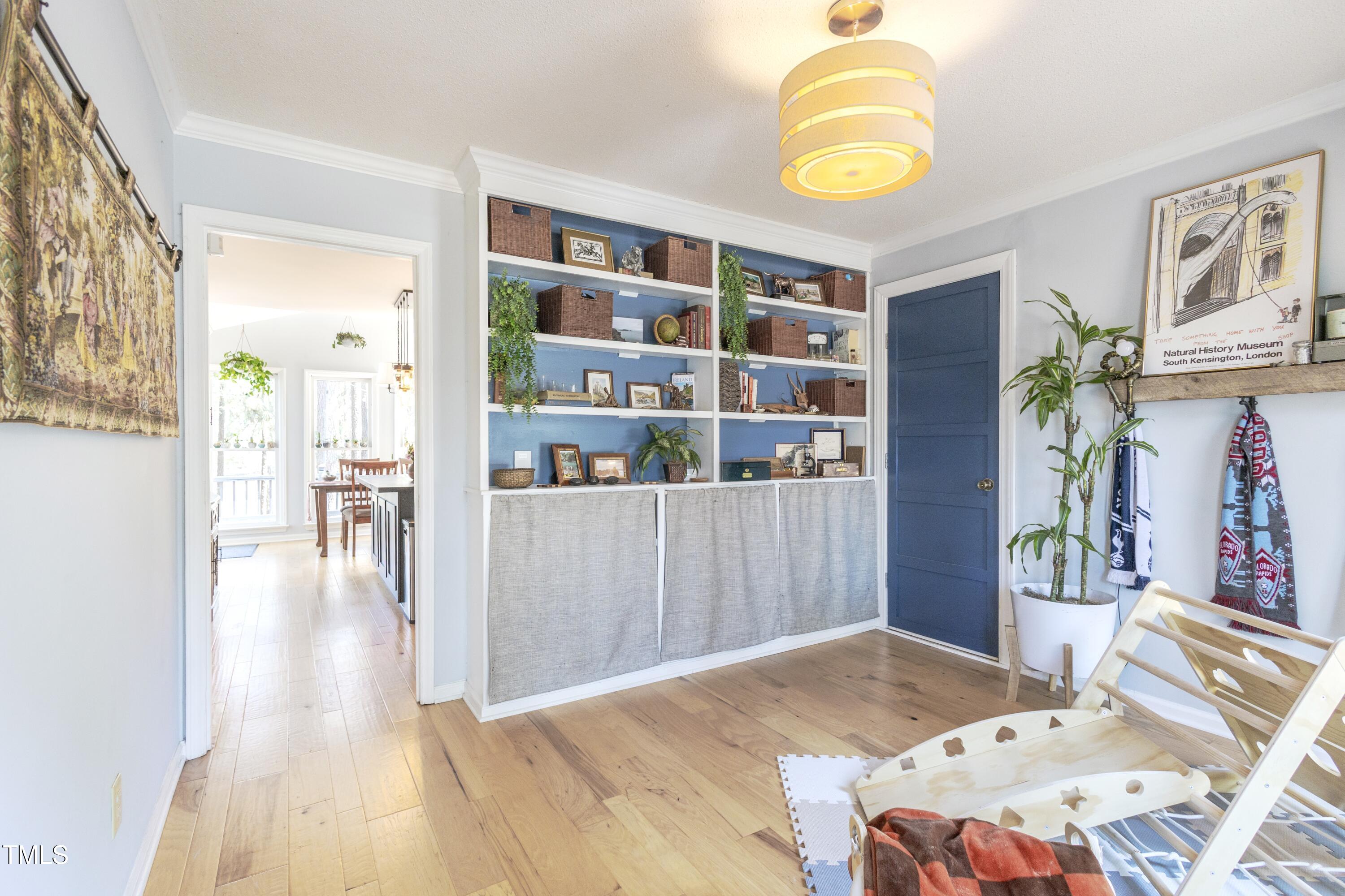 116 Lakeshore Drive Durham, NC 27713 - Photo 13 of 36 a bedroom with a bed and a book shelf