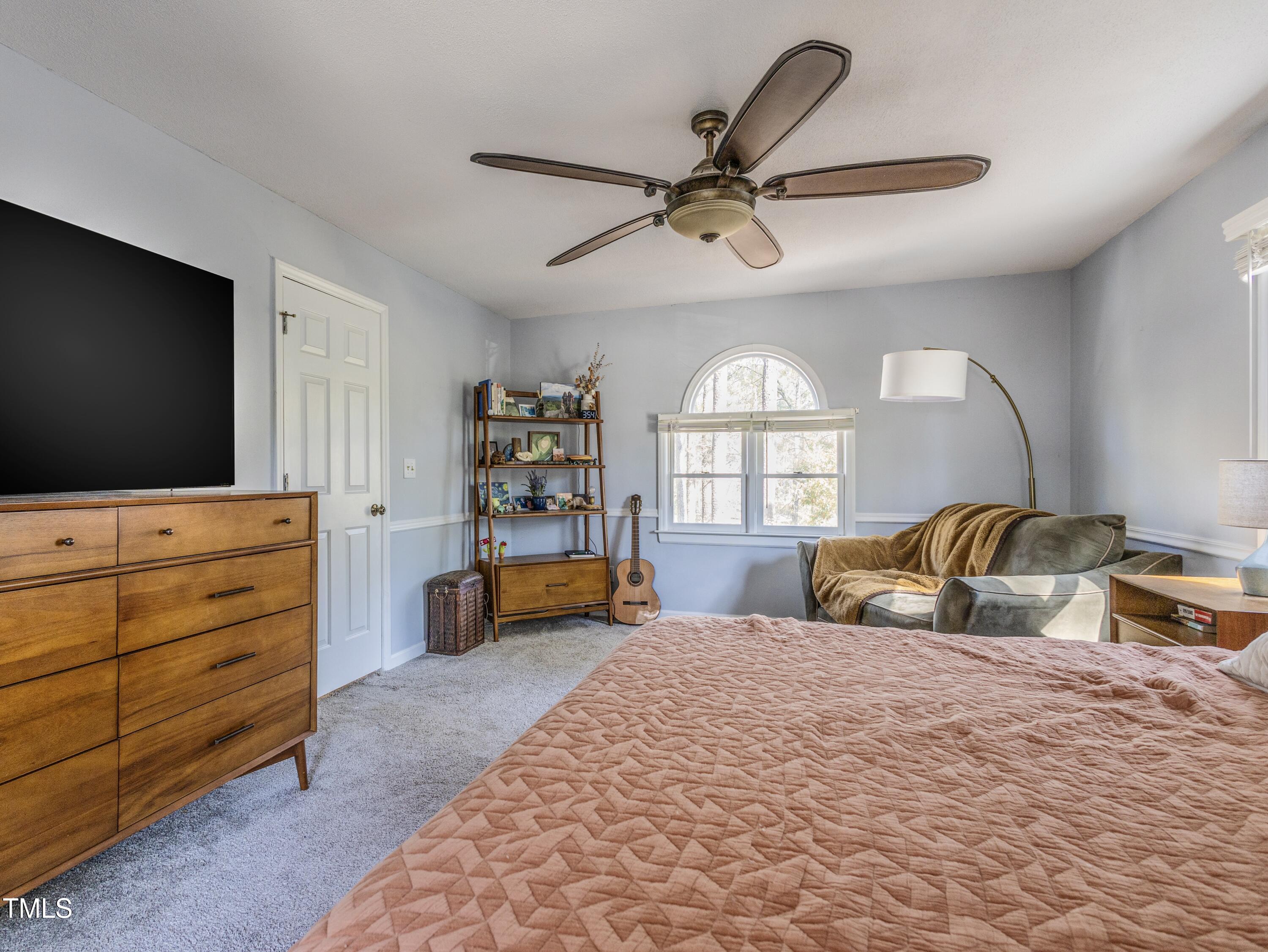 116 Lakeshore Drive Durham, NC 27713 - Photo 17 of 36 a bedroom with a large bed and a flat tv screen on dresser