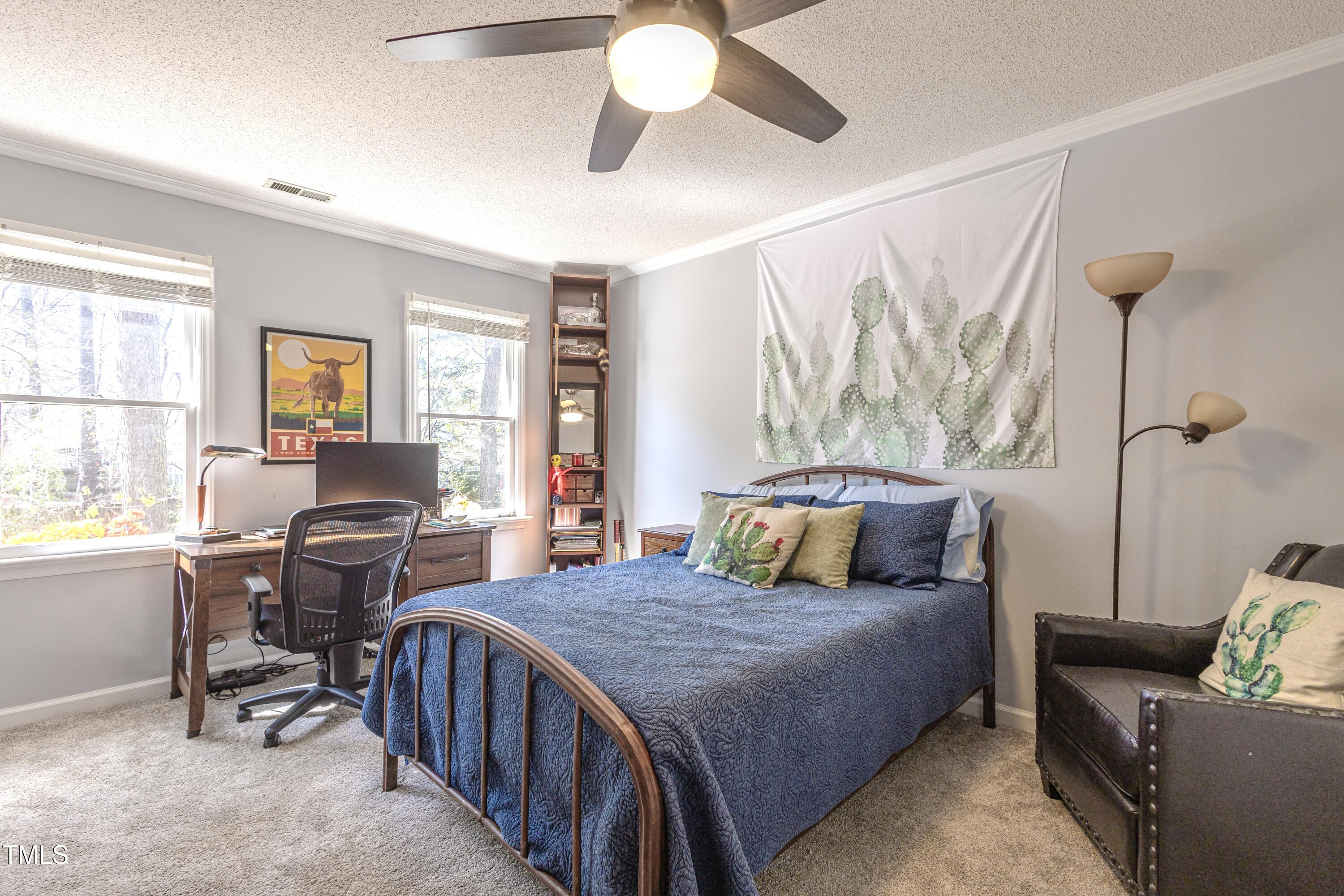 116 Lakeshore Drive Durham, NC 27713 - Photo 22 of 36 a bedroom with a bed and a chandelier