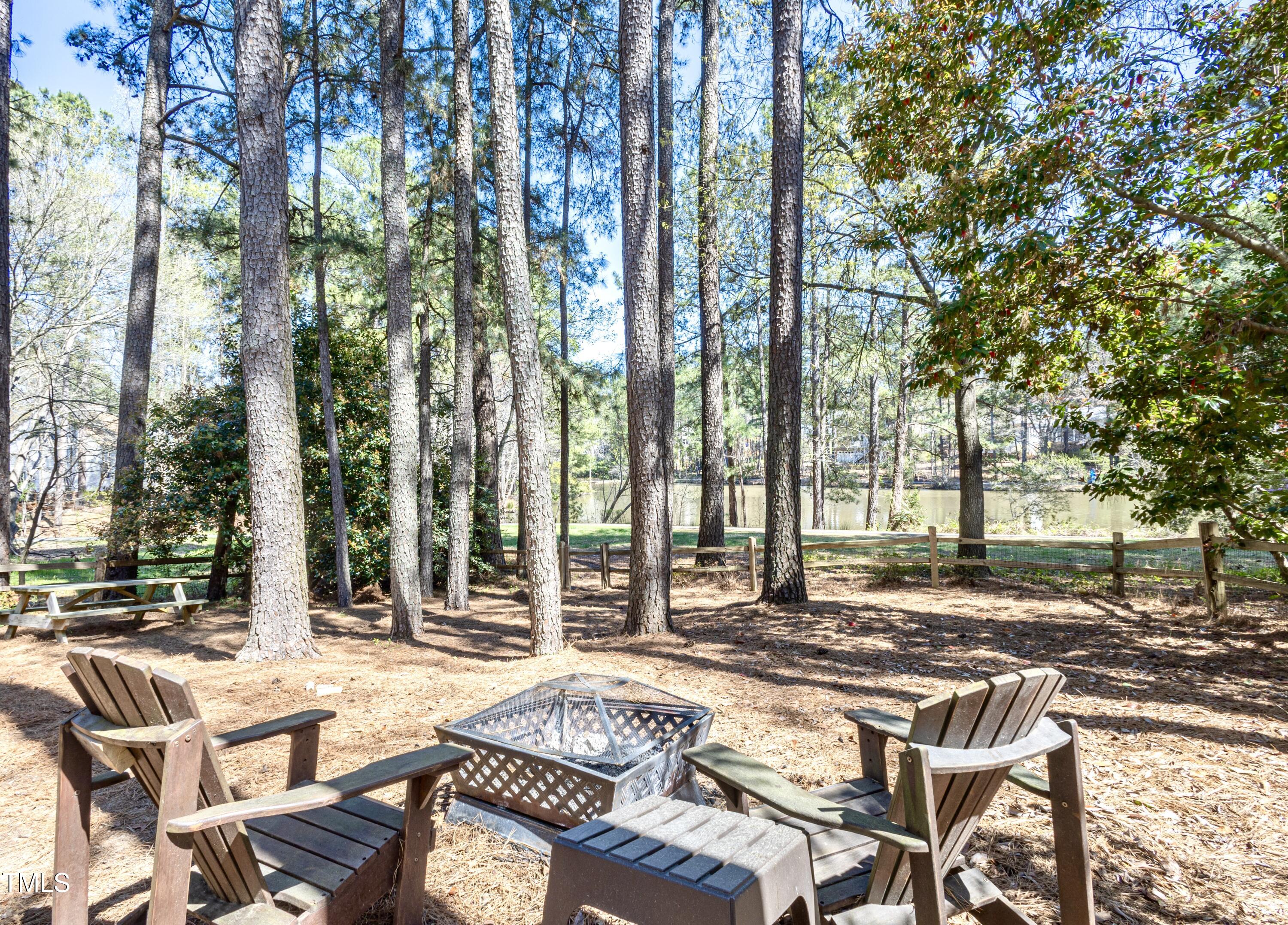116 Lakeshore Drive Durham, NC 27713 - Photo 28 of 36 a view of a patio with a table and chairs and wooden fence