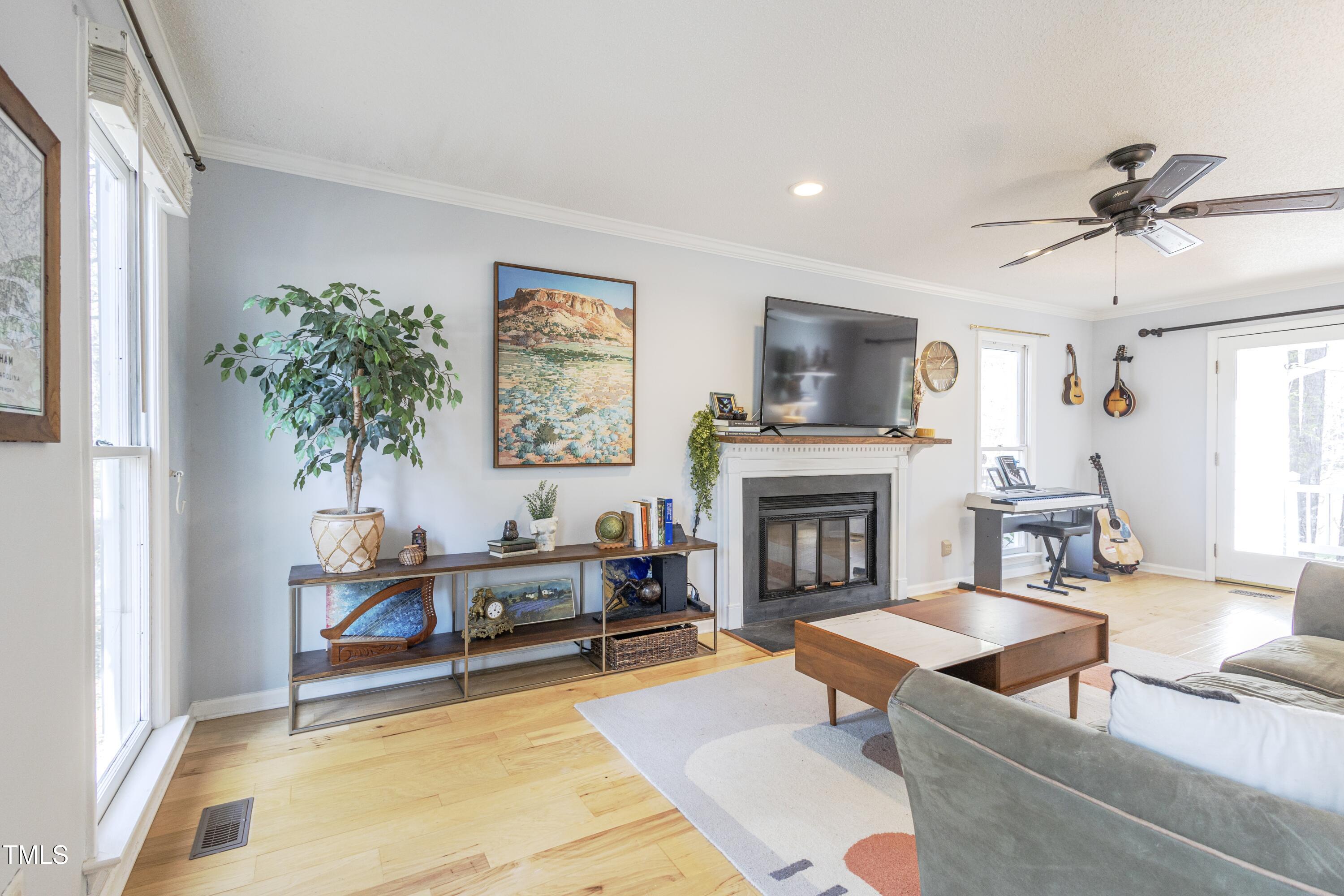 116 Lakeshore Drive Durham, NC 27713 - Photo 3 of 36 a living room with furniture and a fireplace