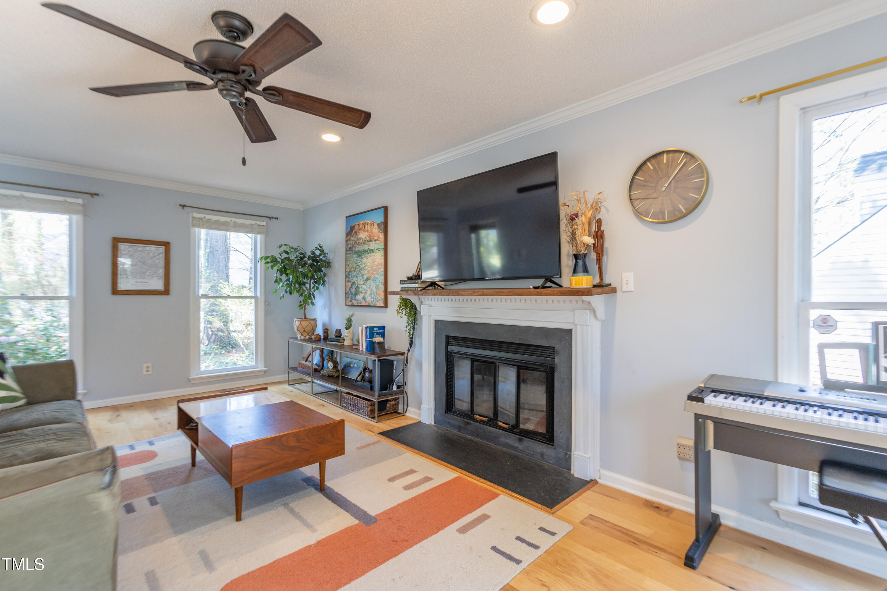 116 Lakeshore Drive Durham, NC 27713 - Photo 4 of 36 a living room with furniture a clock and a fireplace