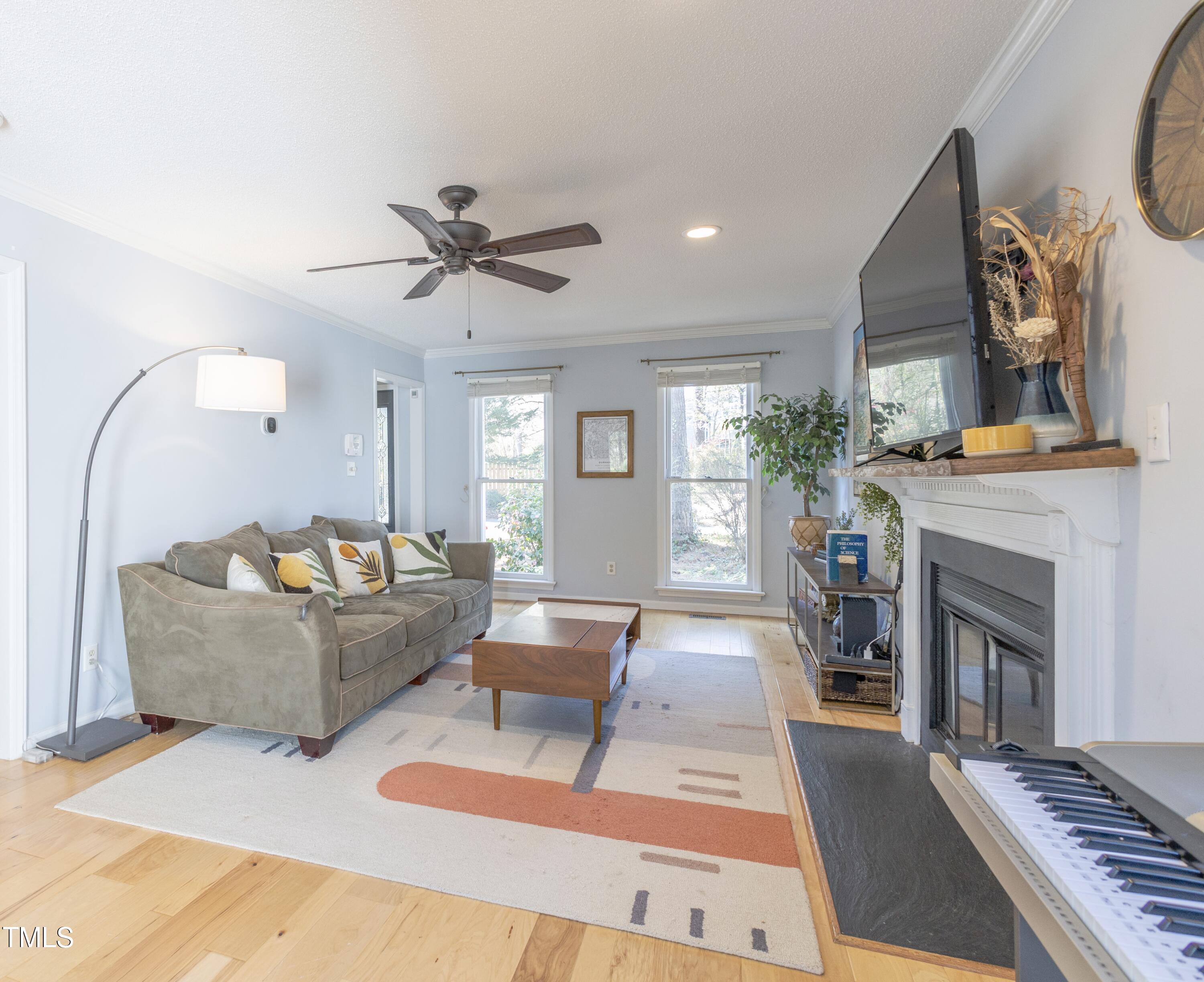 116 Lakeshore Drive Durham, NC 27713 - Photo 5 of 36 a living room with furniture a fireplace and a chandelier