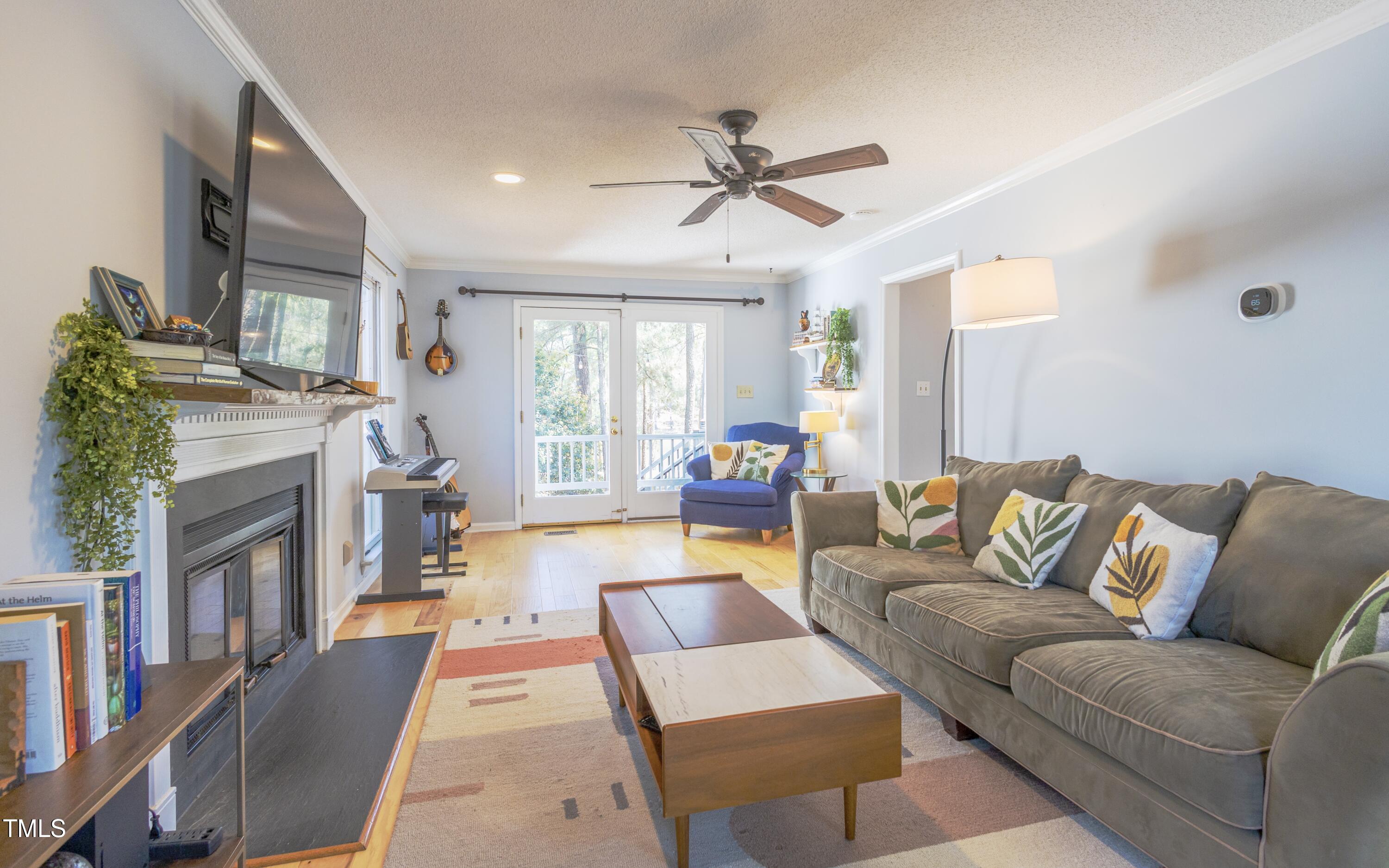 116 Lakeshore Drive Durham, NC 27713 - Photo 6 of 36 a living room with furniture and a fireplace