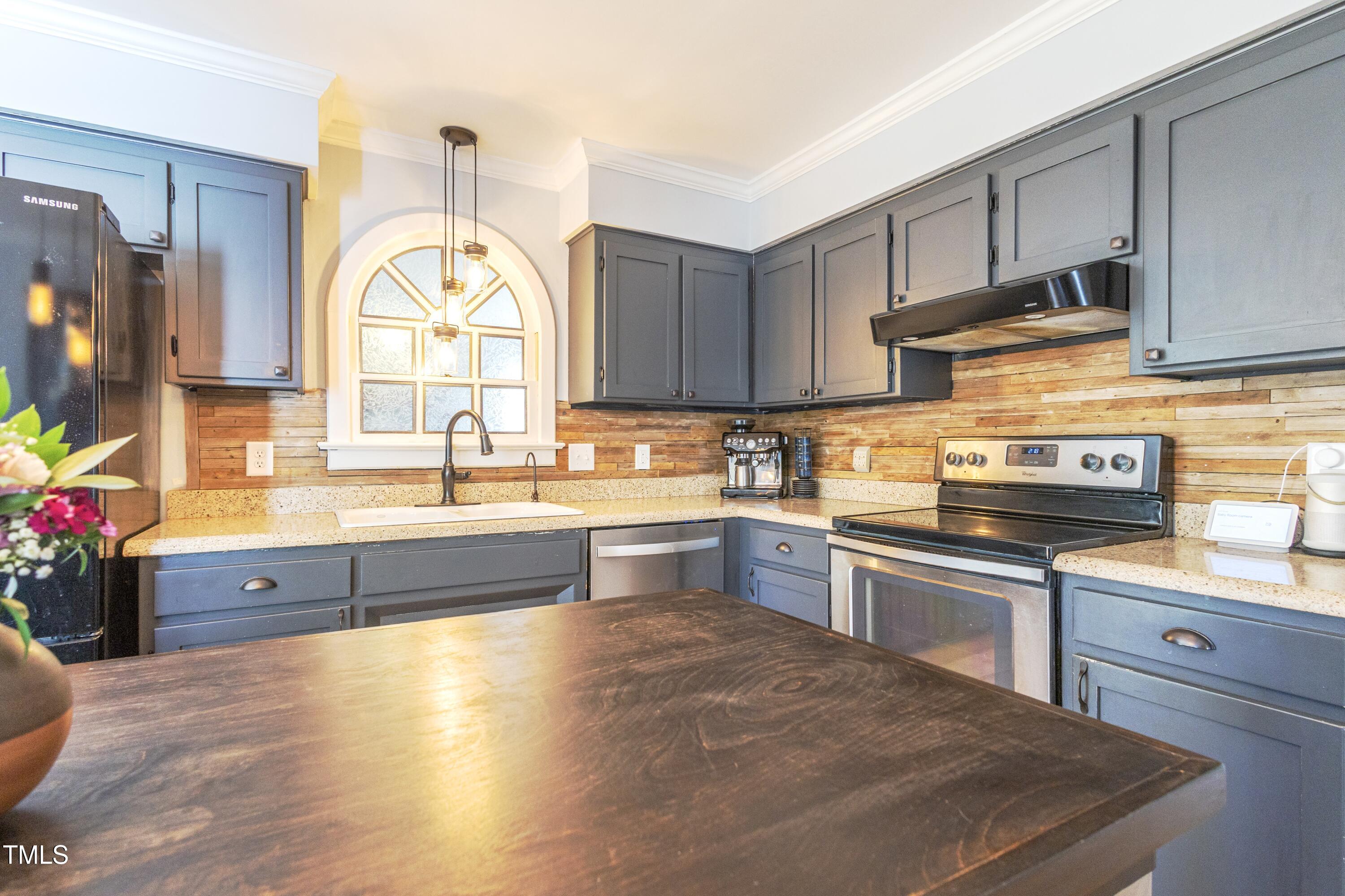 116 Lakeshore Drive Durham, NC 27713 - Photo 9 of 36 a kitchen with granite countertop a stove a sink and a wooden cabinets