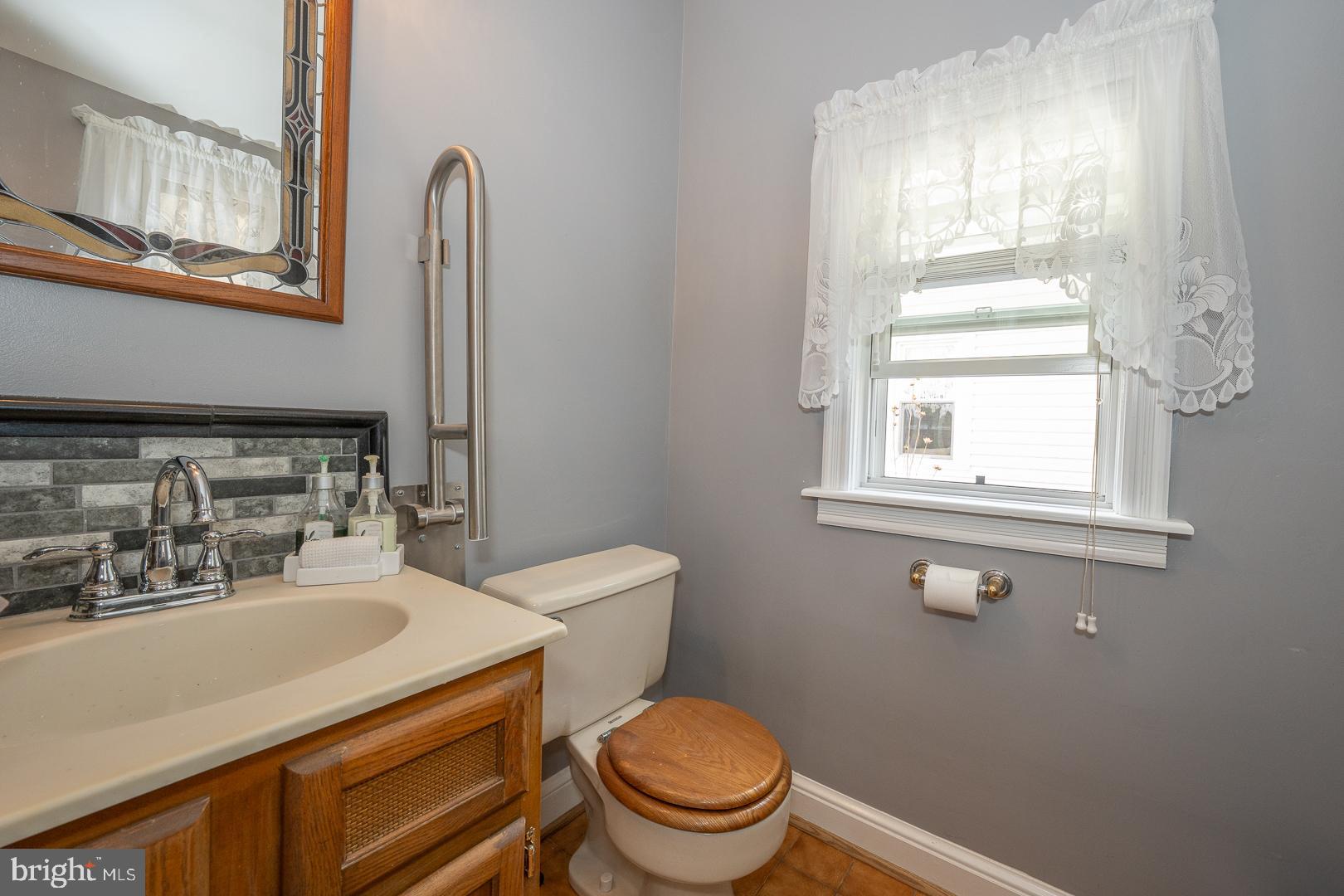 255 Willow Avenue Wayne, PA 19087 - Photo 23 of 46 a bathroom with a sink a toilet and a window