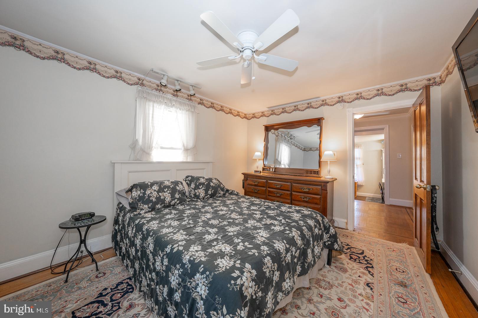 255 Willow Avenue Wayne, PA 19087 - Photo 32 of 46 a bedroom with a bed and a chandelier
