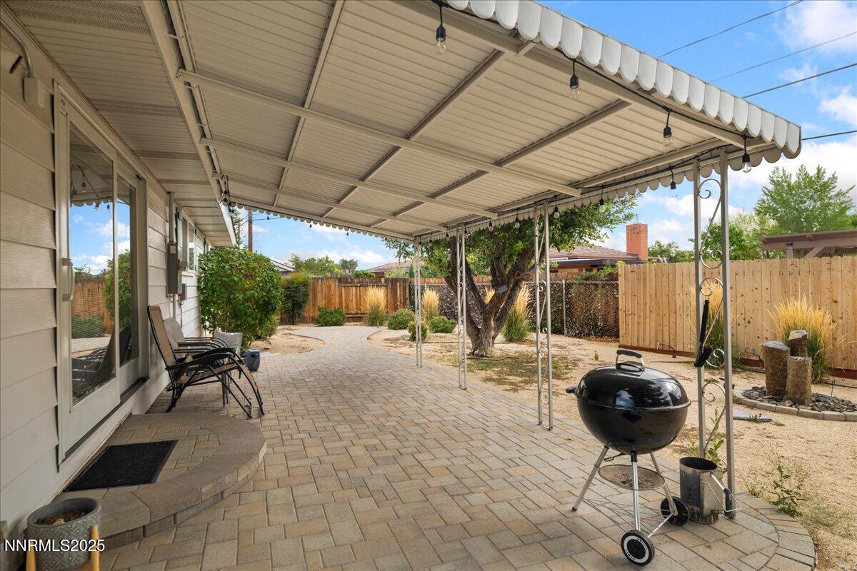610 Akard Circle Reno, NV 89503 - Photo 21 of 28 a view of a patio with table and chairs under an umbrella with a barbeque