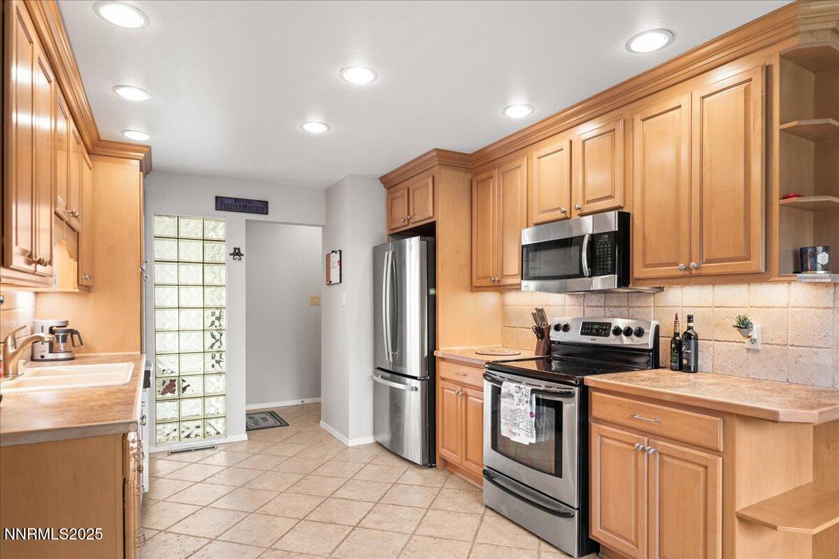 610 Akard Circle Reno, NV 89503 - Photo 4 of 28 a kitchen with stainless steel appliances granite countertop a refrigerator a stove top oven a sink and dishwasher