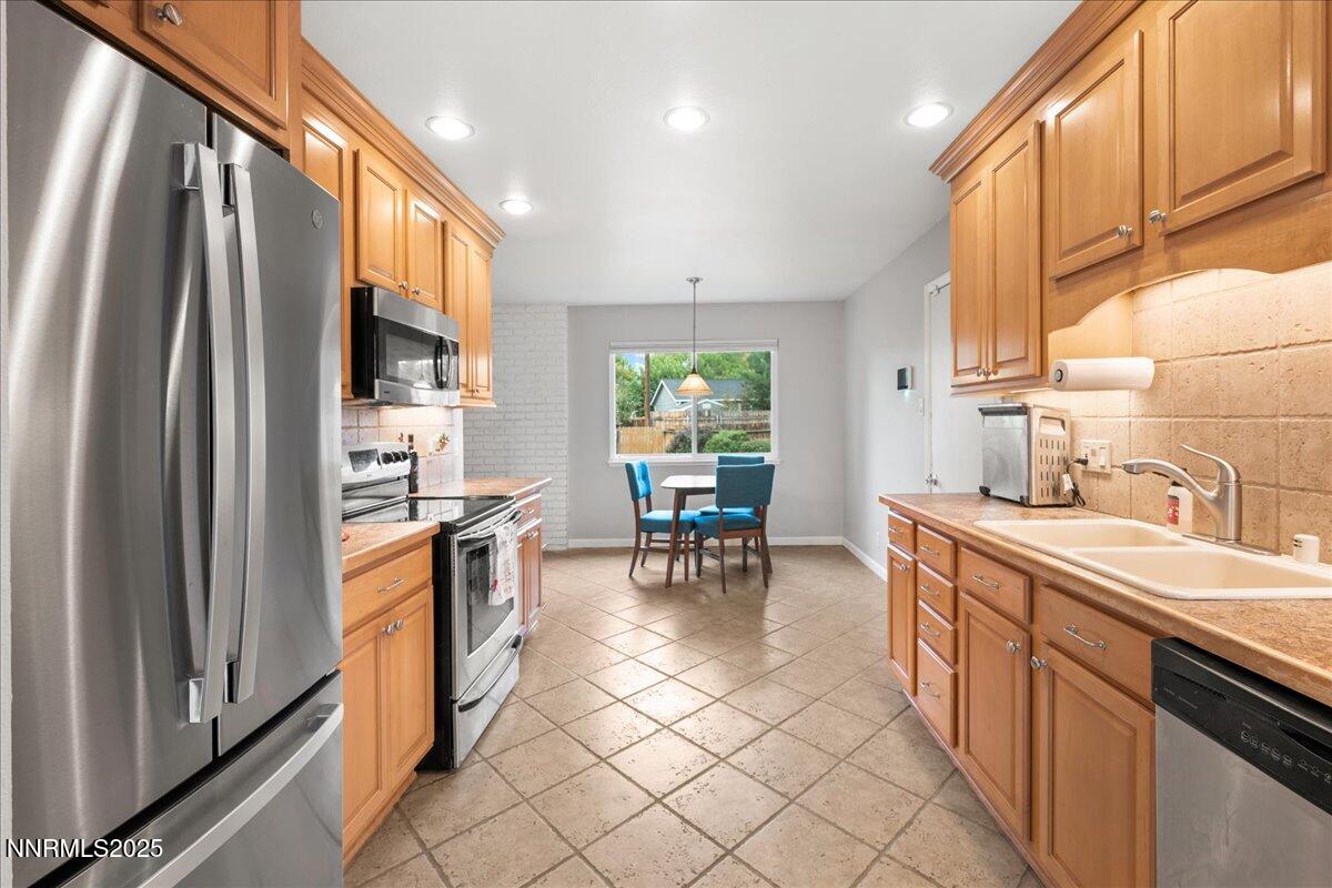 610 Akard Circle Reno, NV 89503 - Photo 5 of 28 a kitchen with sink cabinets and window