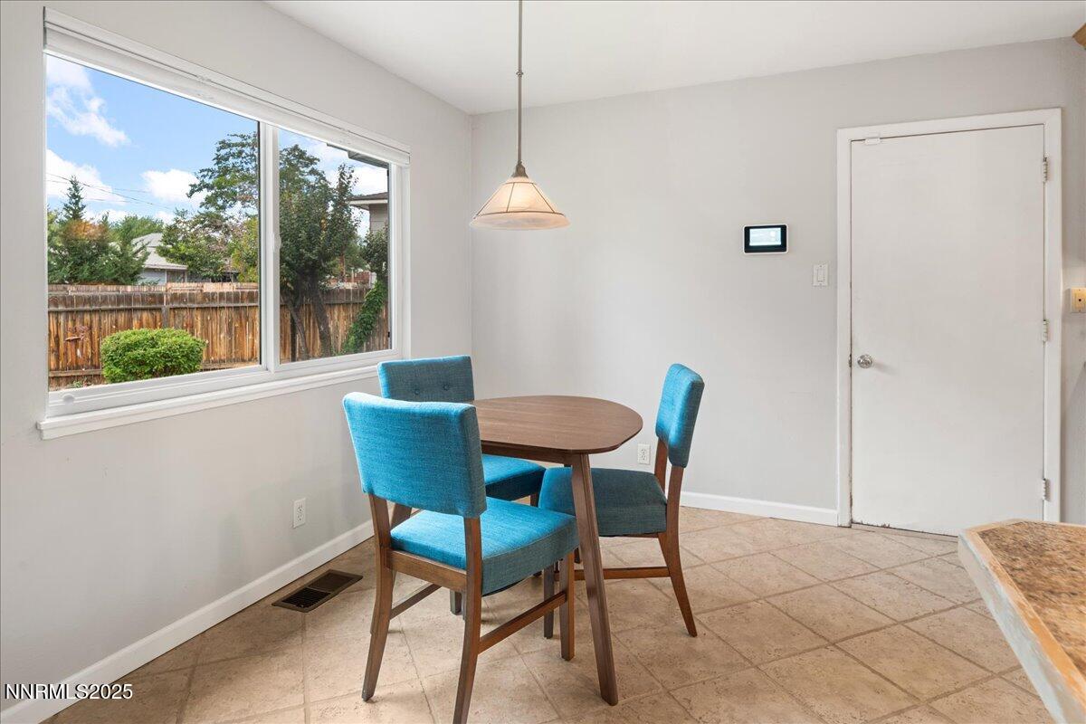 610 Akard Circle Reno, NV 89503 - Photo 7 of 28 a dining room with furniture a chandelier and a rug