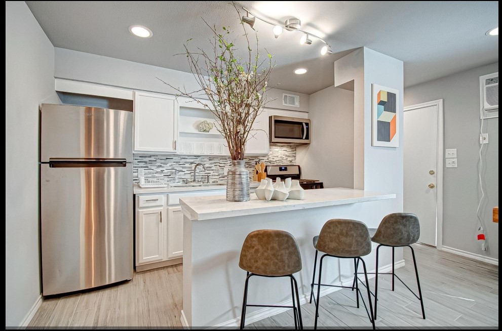 1903 Commonwealth Street, Unit 31 Houston, TX 77006 - Photo 2 of 6 a kitchen with stainless steel appliances granite countertop a refrigerator and a stove top oven