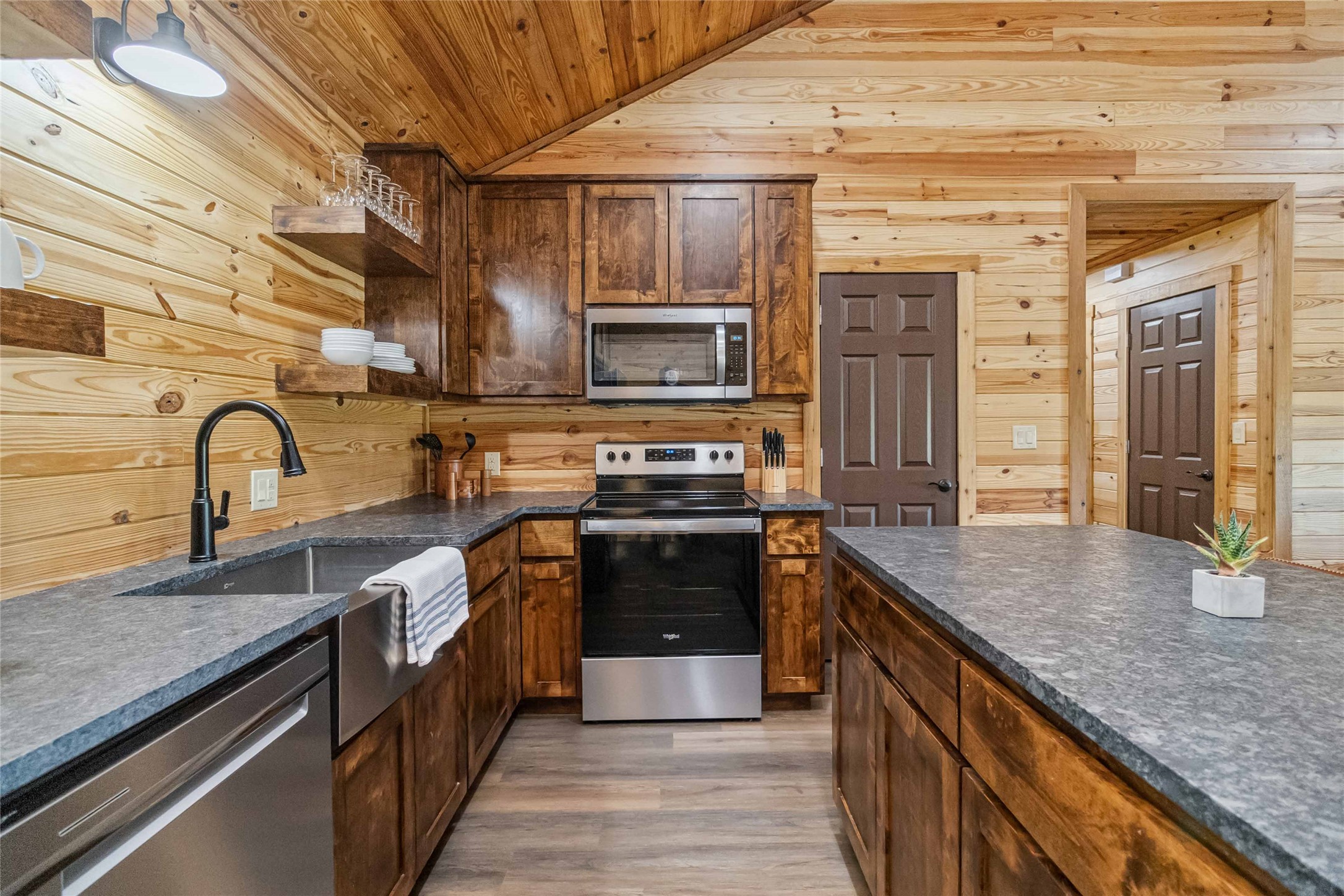 1591 Scull Road San Marcos, TX 78666 - Photo 9 of 26 Kitchen featuring open shelves, a sink, appliances with stainless steel finishes, wood walls, and wooden ceiling
