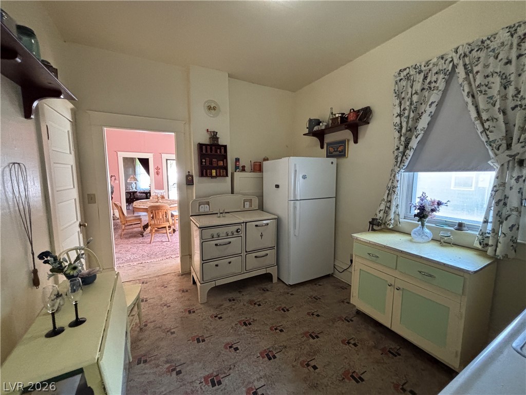 591 Campton Street Ely, NV 89301 - Photo 14 of 29 Kitchen with open shelves, freestanding refrigerator, and light countertops