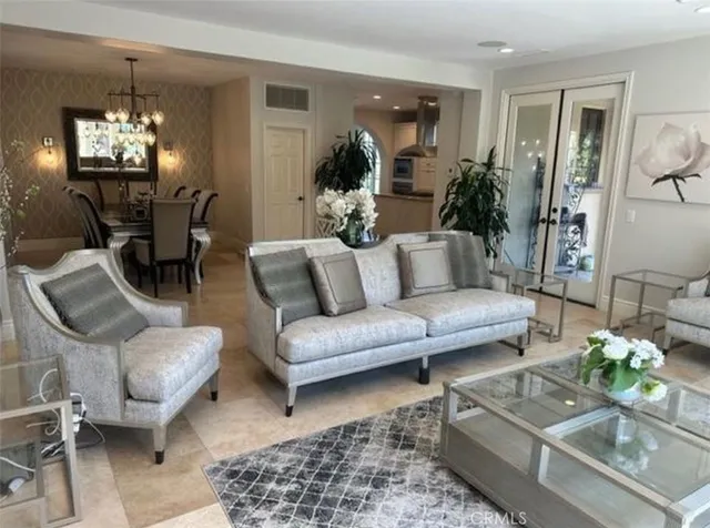 a living room with furniture and a chandelier