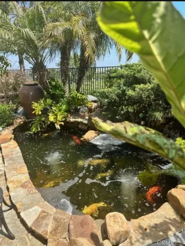 a view of swimming pool of water with lawn chairs