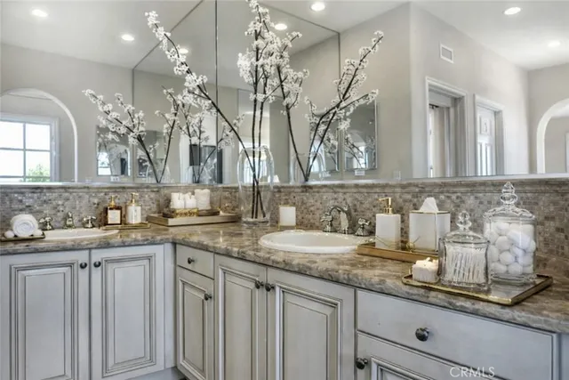 a bathroom with double sink and a mirror
