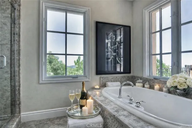 a bathroom with a tub and window