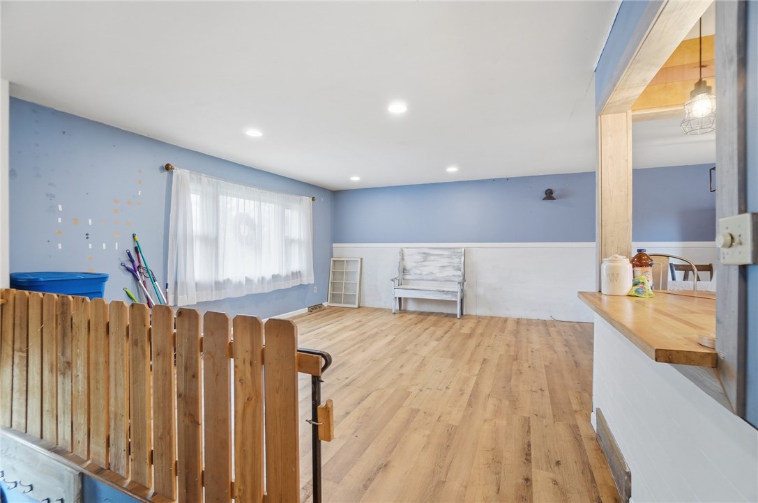290 Ginghamsburg Road Tipp City, OH 45371 - Photo 6 of 49 This versatile open-concept space features warm wood flooring, offering endless possibilities.