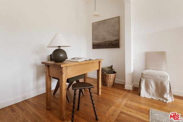 a workspace with furniture and wooden floor