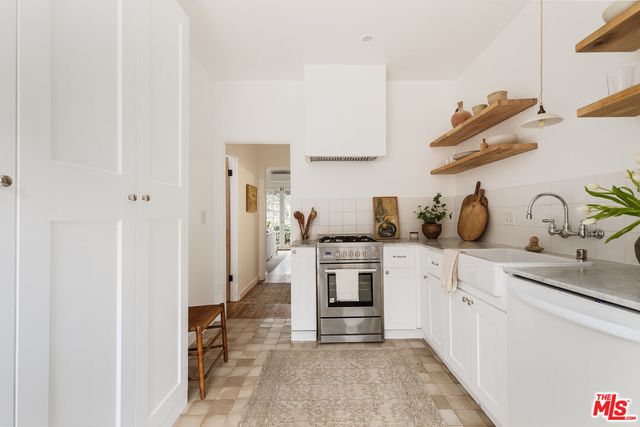 a kitchen with cabinets and appliances