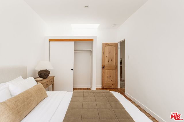 a view of a room that has a bed and chair