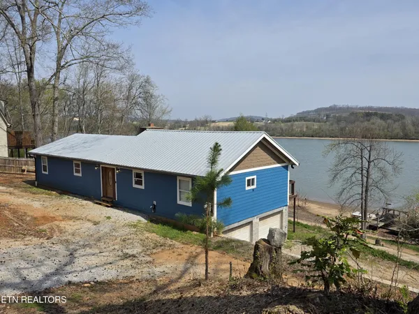 a aerial view of a house next to a yard