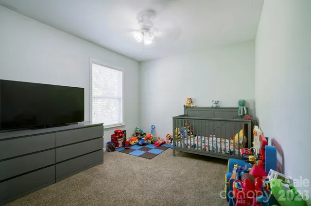 a bedroom with furniture and a flat screen tv
