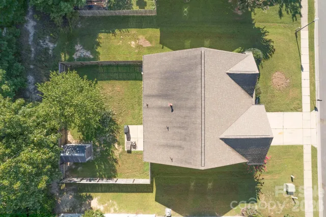 an aerial view of a house with a lake view